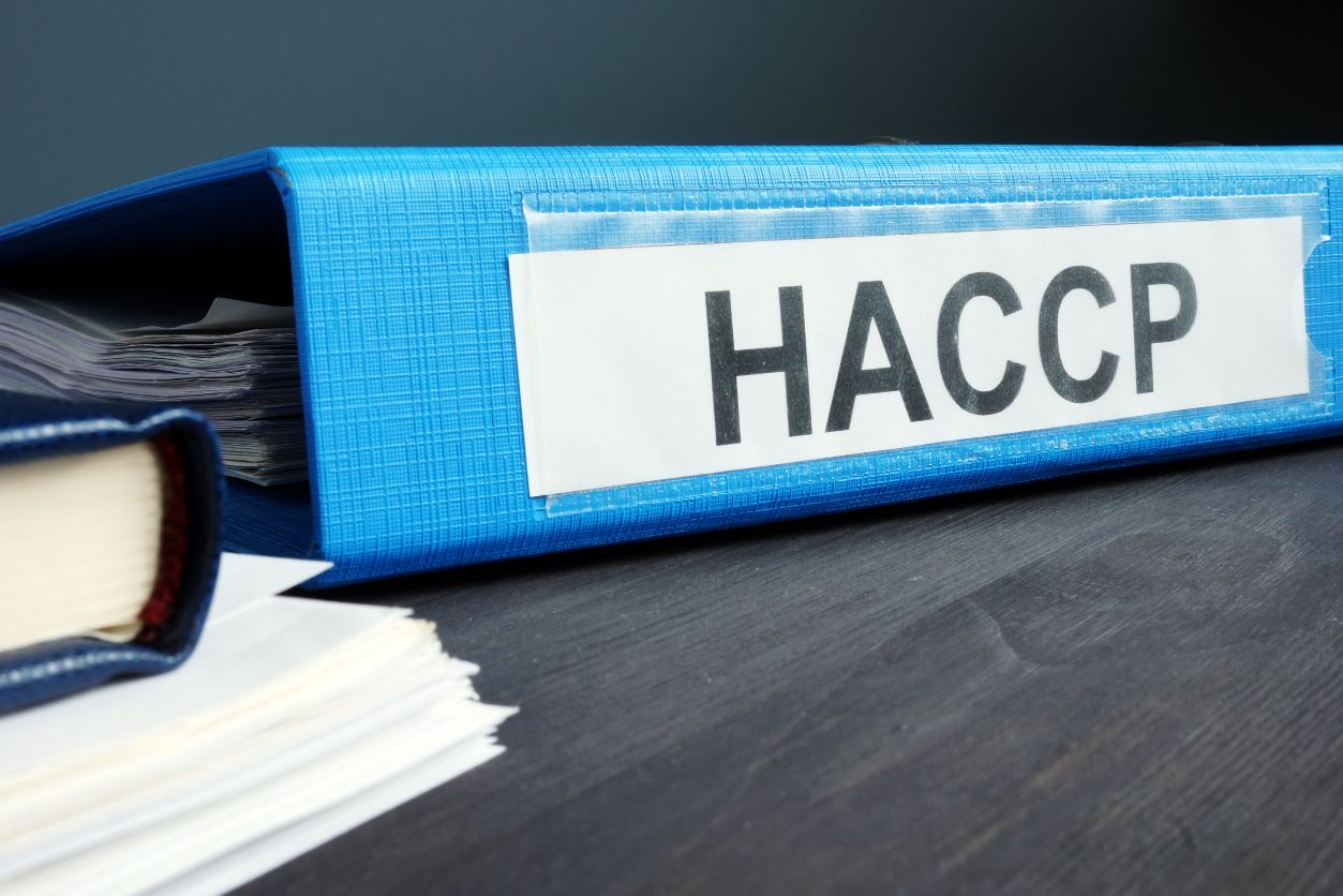 A binder holding a HACCP Hazard Analysis