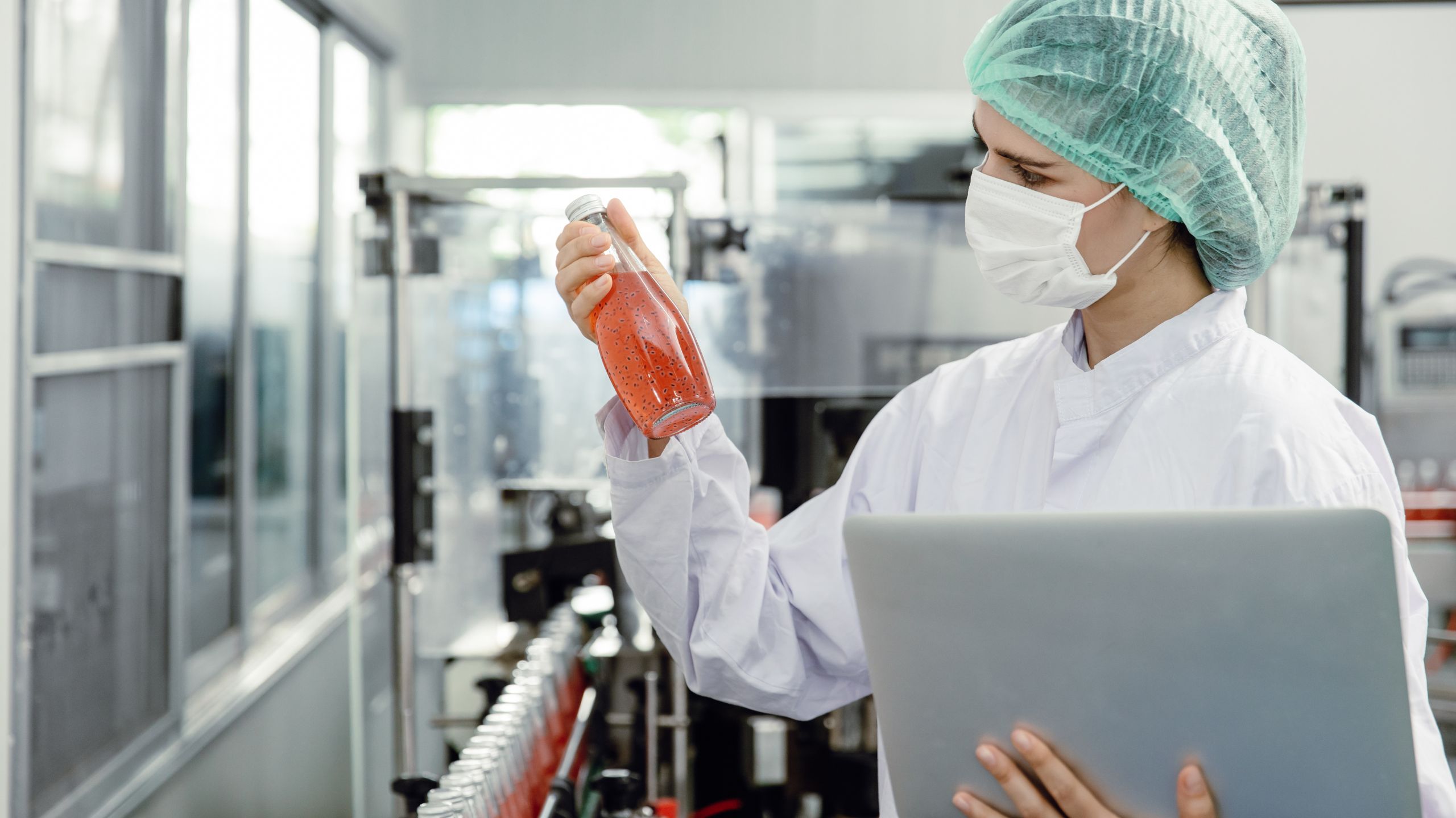 An SQF Practitioner evaluates a food and beverage product fresh off the production line.