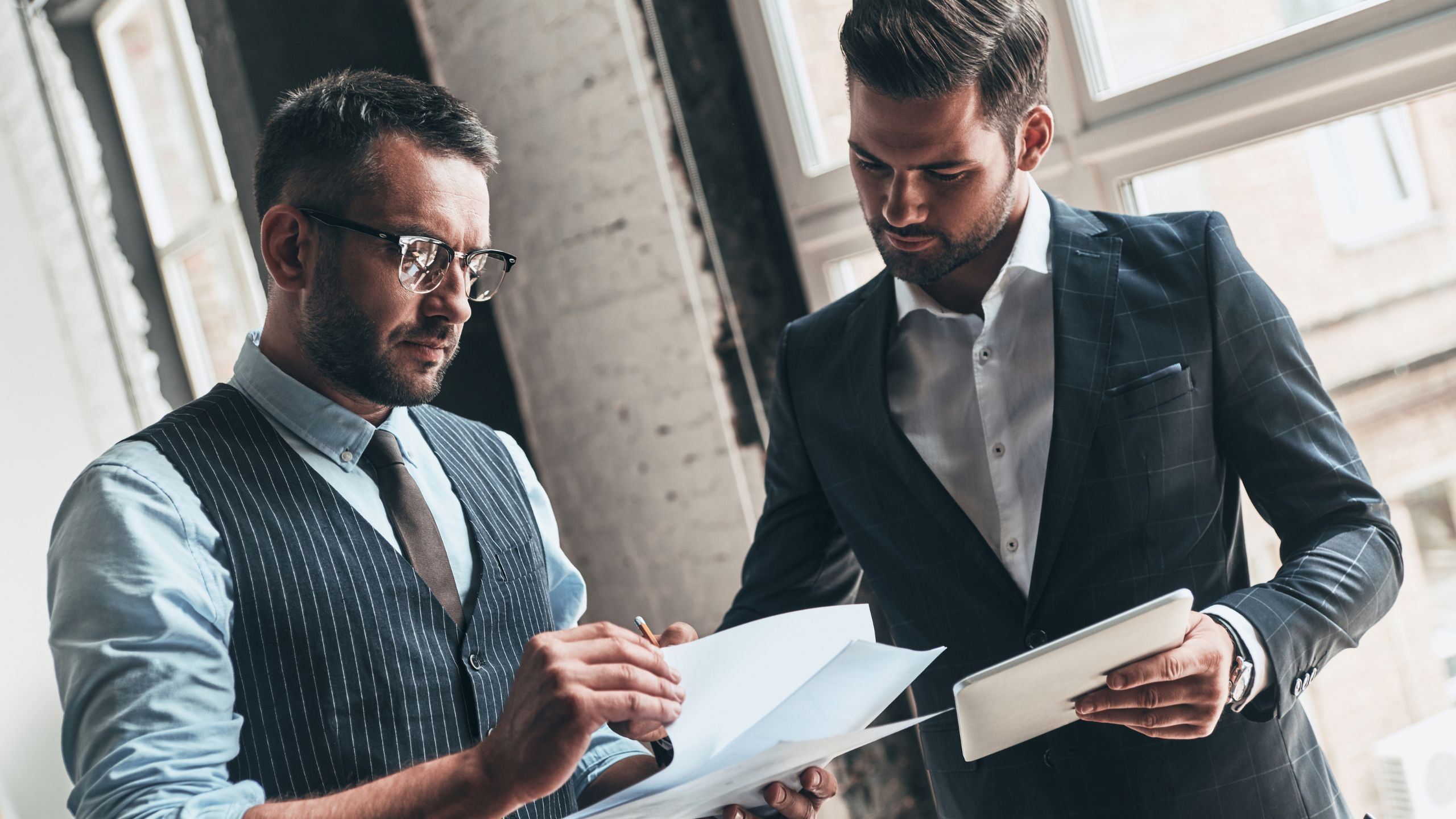 Two men discuss the qualifications and requirements of a PCQI.
