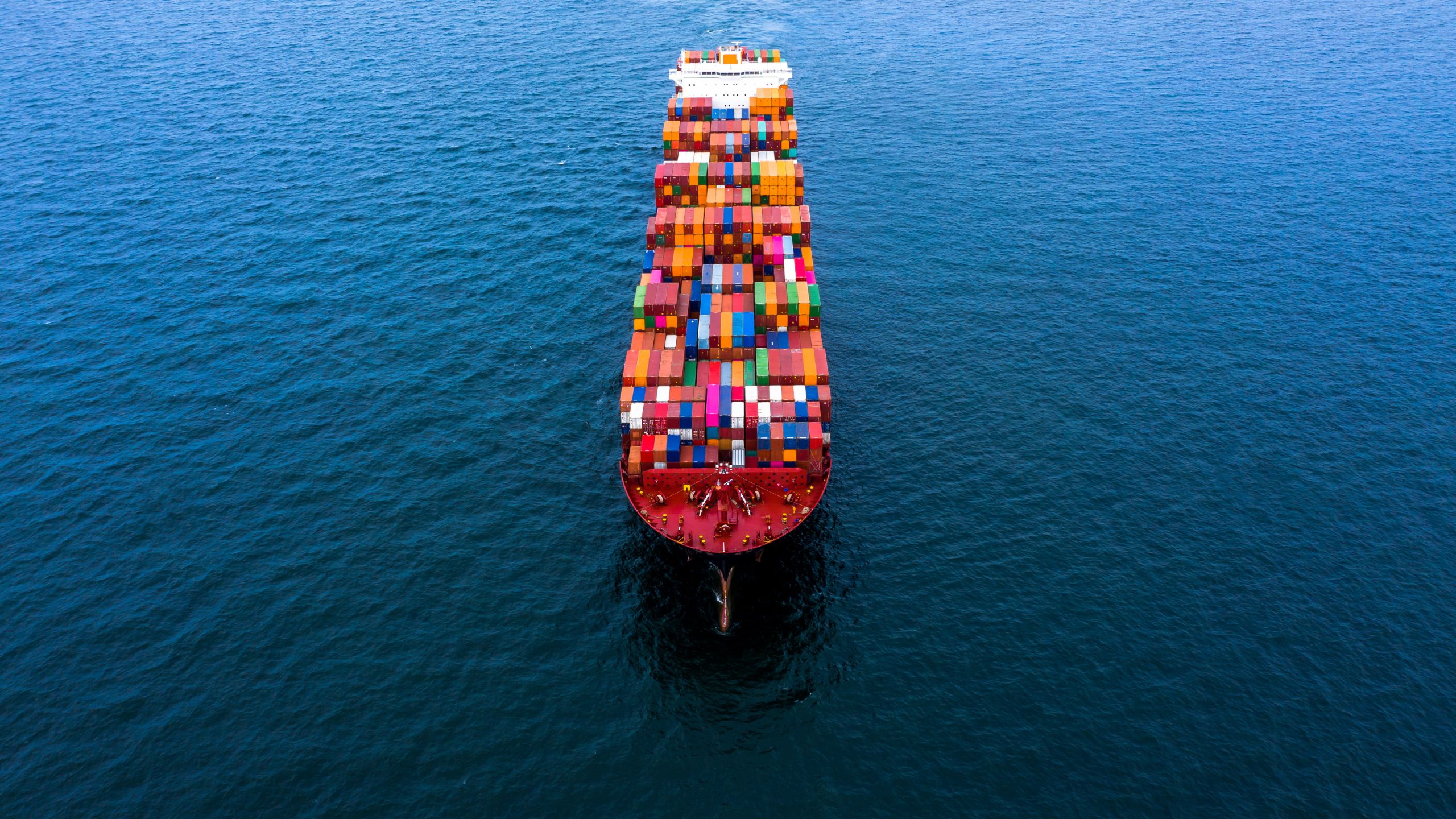 A cargo ship sails on open waters carrying product from suppliers that a PCQI has confirmed are both SQF & FSVP compliant.