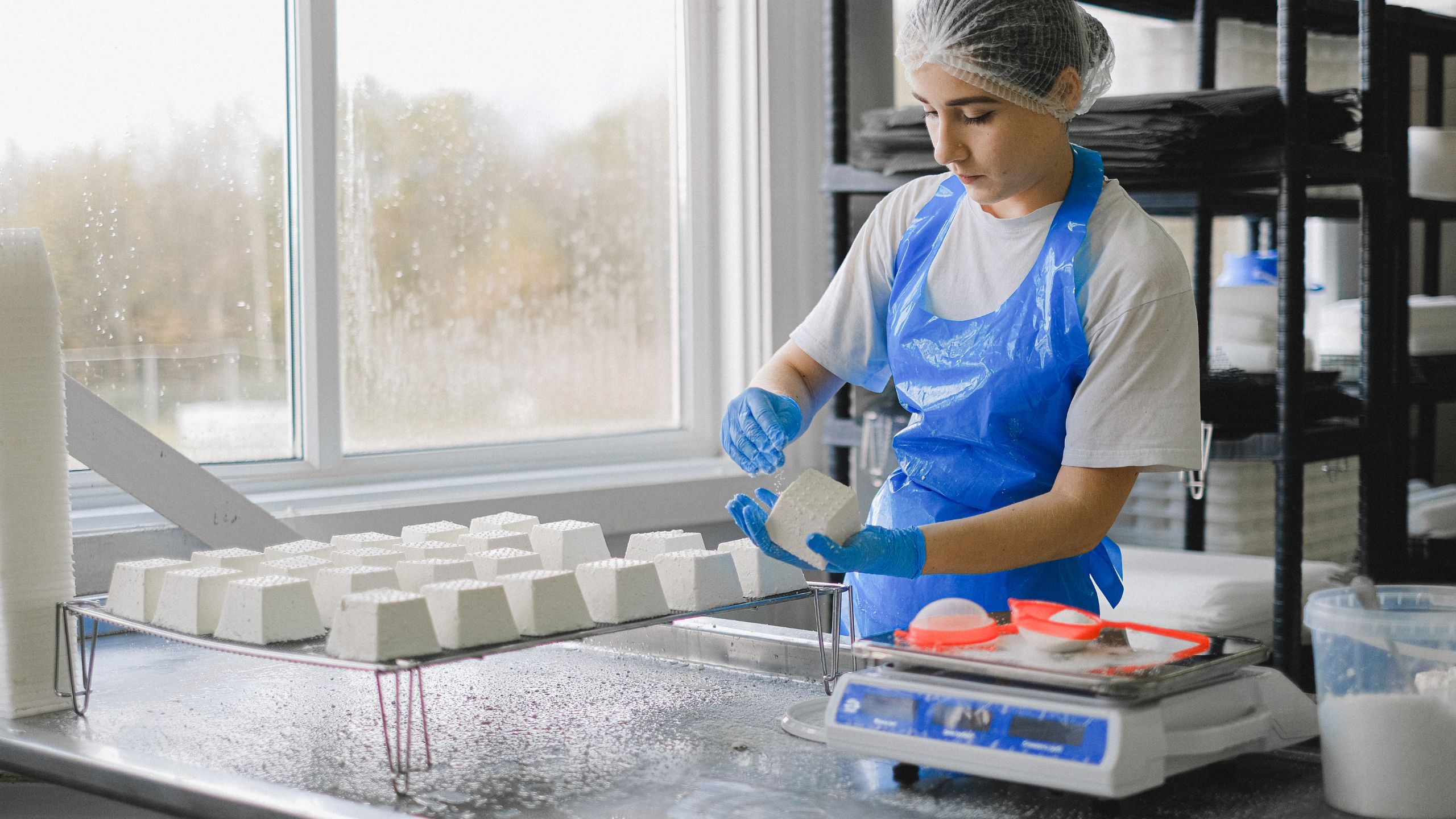 A food service employee follows the sanitation controls set forth by the company's PCQI.