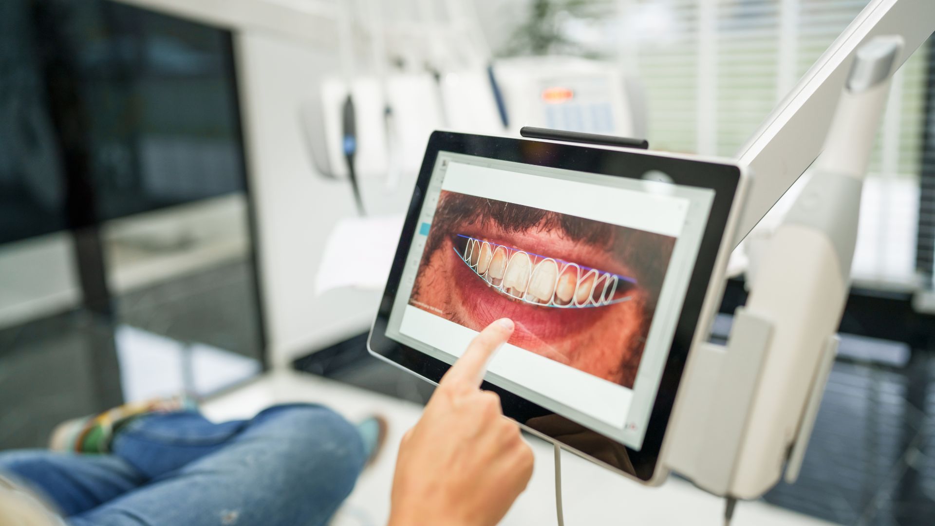A smart dental device shows a mans teeth mapped across an interactive screen.